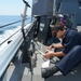 Sailors at work aboard USS Laboon