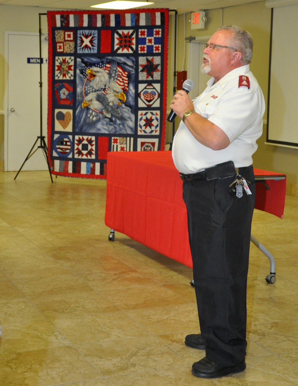 Major David Ebel, pastor with The Salvation Army, offers opening prayer at farewell lunch for Colonel Michael L. Scalise, June 25