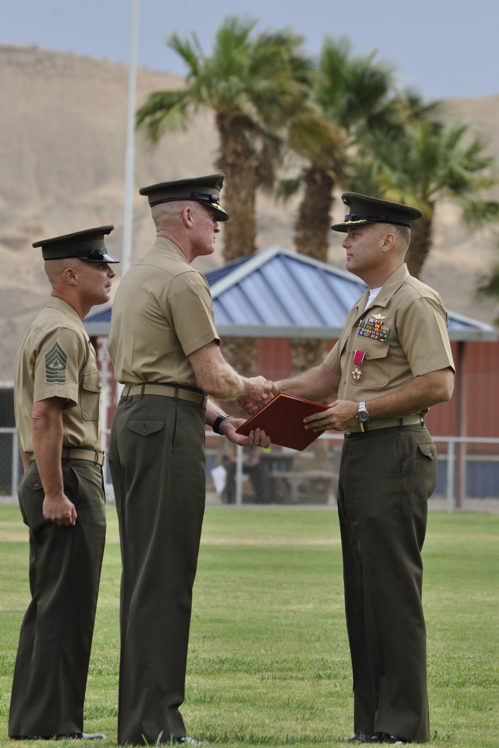 Brig. Gen. Edward Banta, commanding general Marine Corps Installations West, Marine Corps Base Camp Pendleton congratulates Col. Michael L. Scalise after presenting him with the Legion of Merit for exemplary service