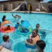 Wet baby buggy bumpers gently collide in the pool as military families enjoy food and games at the Oasis Pool and Water Park aboard Marine Corps Logistics Base Barstow, Calif., during the All American BBQ, July 4