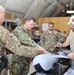US Navy Rear Adm. Luke McCollum, vice commander, US Naval Forces Central Command, examines ScanEagle avionics system at Kandahar Airfield June 25, 2015