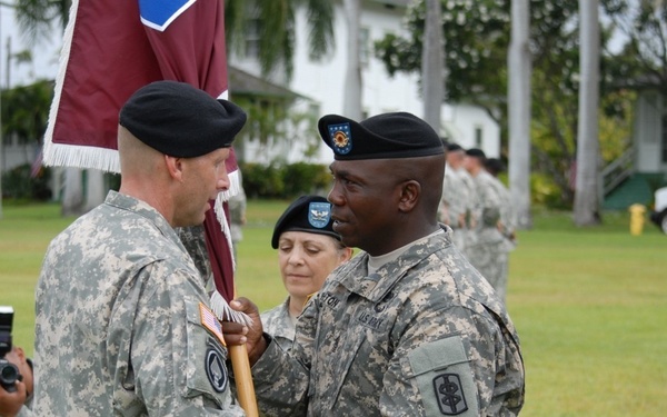 Command Sgt. Major Wrighton passes Col. Ackermann the colors
