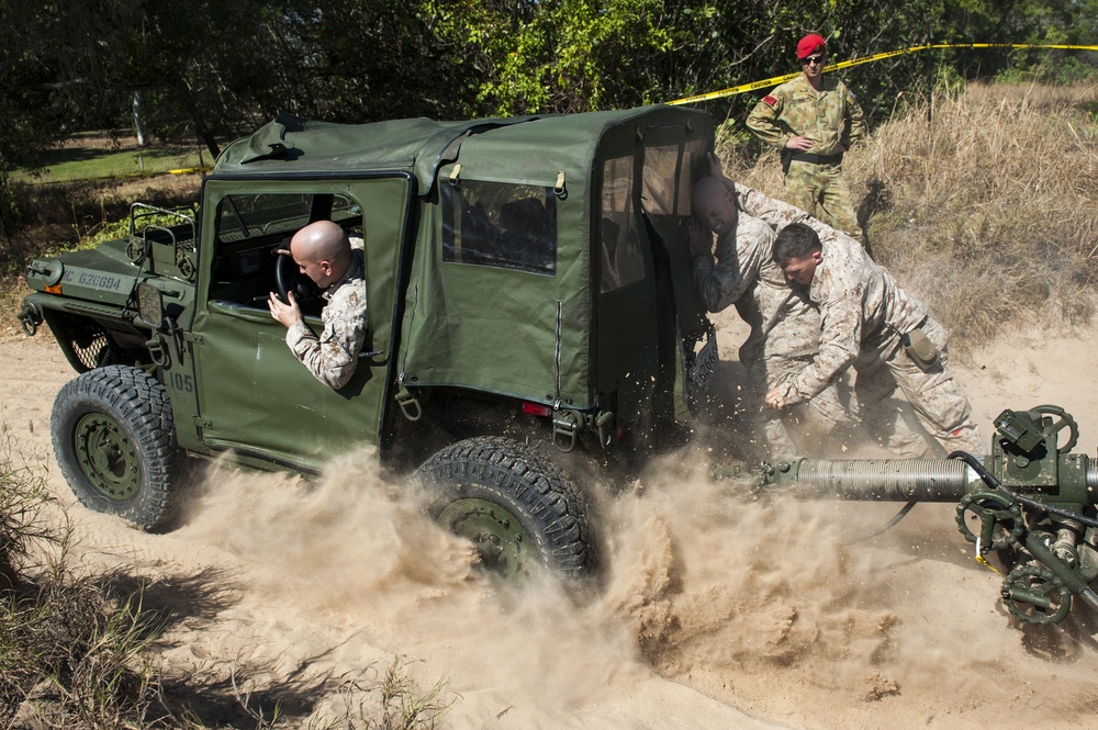 U.S. Marines work together to push a M151 jeep out of the sand during Talisman Sabre 2015