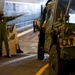 U.S. Sailor directs equipment and cargo onto a landing craft air cushion vehicle during Talisman Sabre 2015