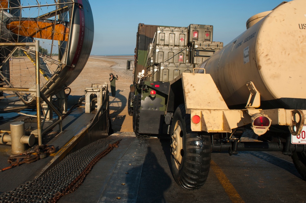 U.S. Sailor offloads a cargo truck from a landing craft air cushion vehicle during Talisman Sabre 2015