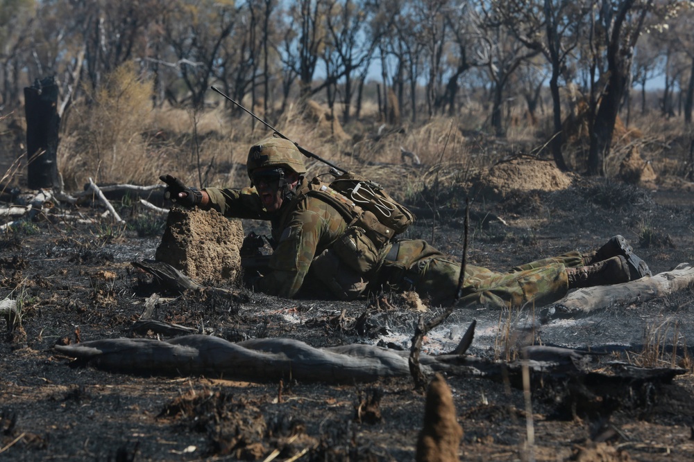 Australian soldiers and U.S. Marines air assault through a mock enemy objective