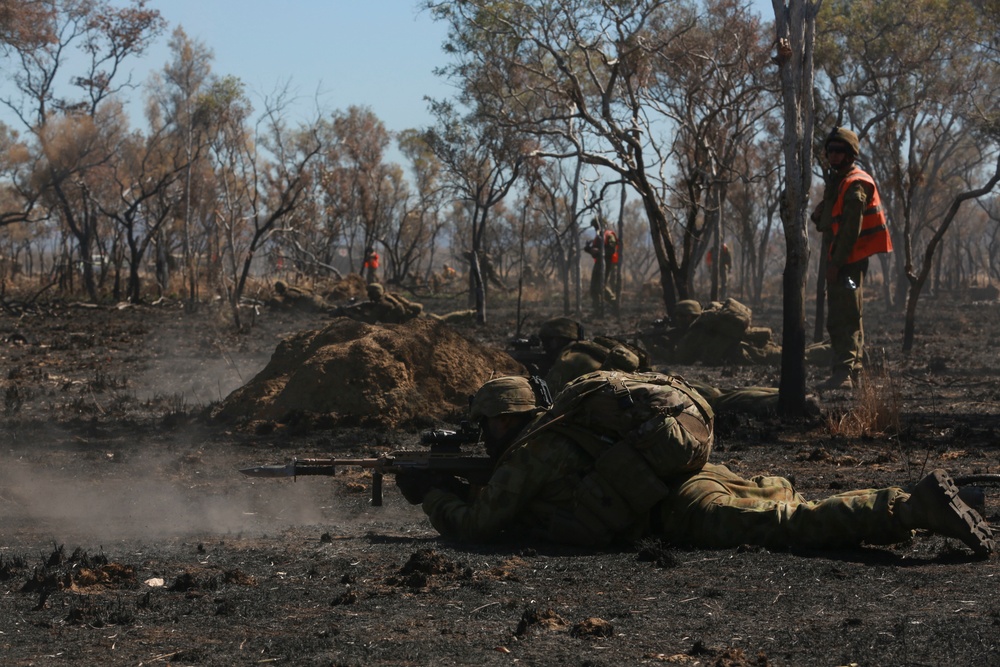 Australian soldiers and U.S. Marines air assault through a mock enemy objective