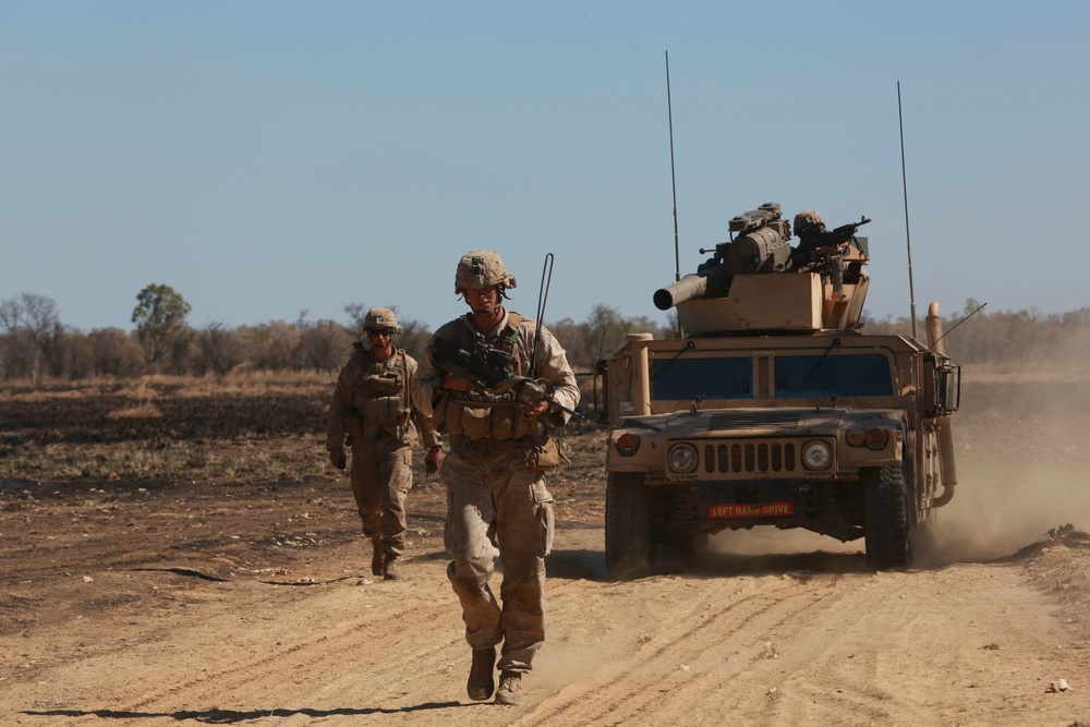 Australian soldiers and U.S. Marines air assault through a mock enemy objective