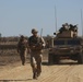 Australian soldiers and U.S. Marines air assault through a mock enemy objective