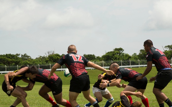 Service members play rugby with local nationals