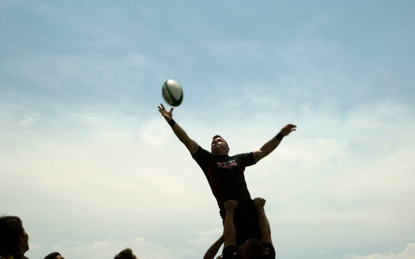 Service members play rugby with local nationals