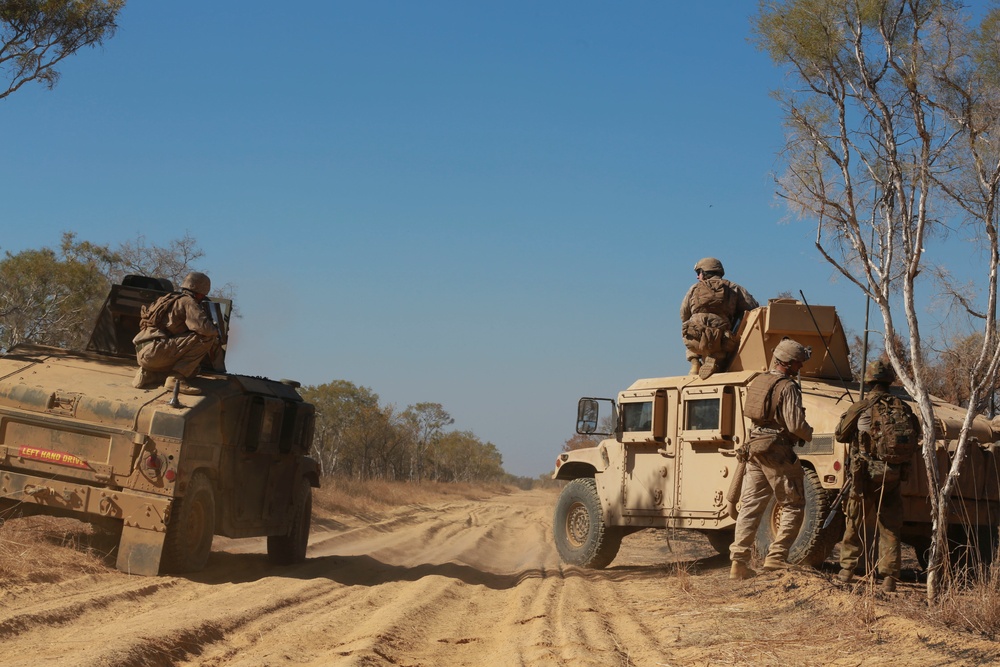 Australian soldiers and U.S. Marines air assault through a mock enemy objective