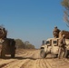 Australian soldiers and U.S. Marines air assault through a mock enemy objective