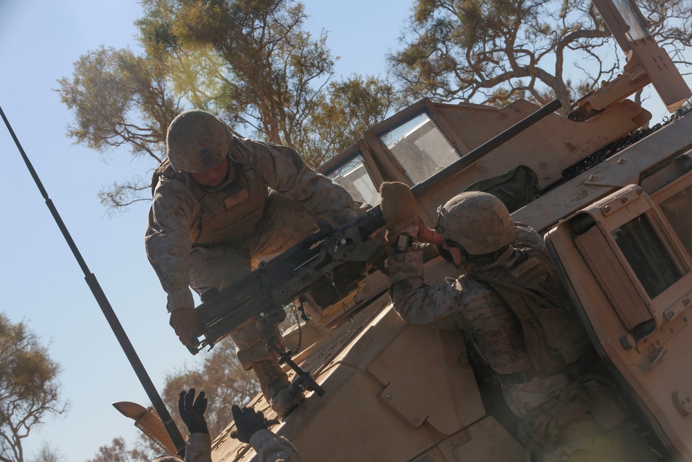 Australian soldiers and U.S. Marines air assault through a mock enemy objective