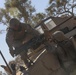 Australian soldiers and U.S. Marines air assault through a mock enemy objective