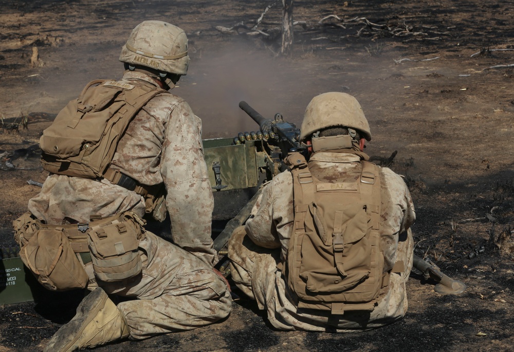 Australian soldiers and U.S. Marines air assault through a mock enemy objective