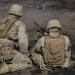 Australian soldiers and U.S. Marines air assault through a mock enemy objective