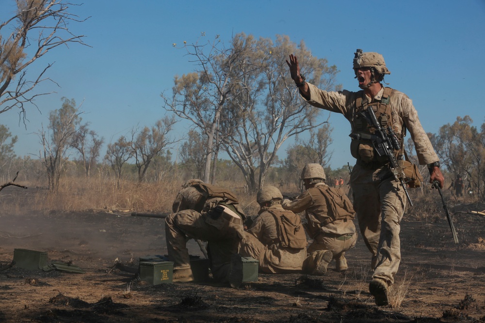 Australian soldiers and U.S. Marines air assault through a mock enemy objective