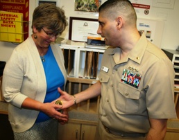 Presenting and receiving of coins a priceless commodity for Navy Nurse Corps officer