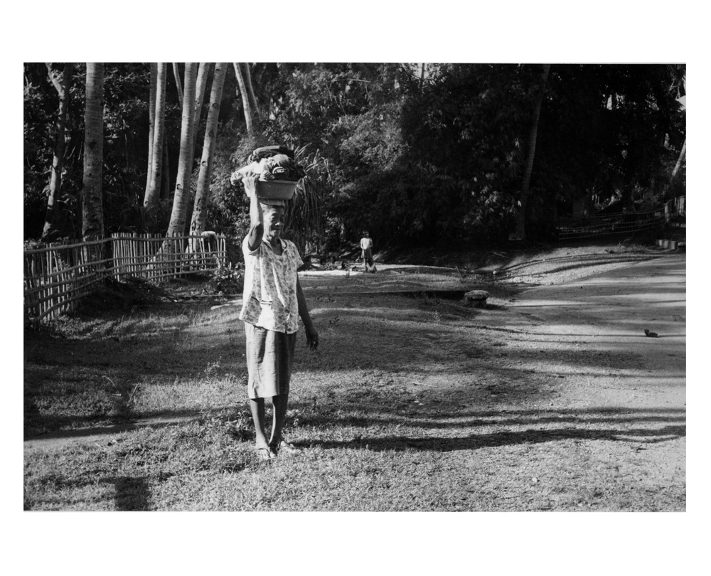 Woman carrying clothes in basket