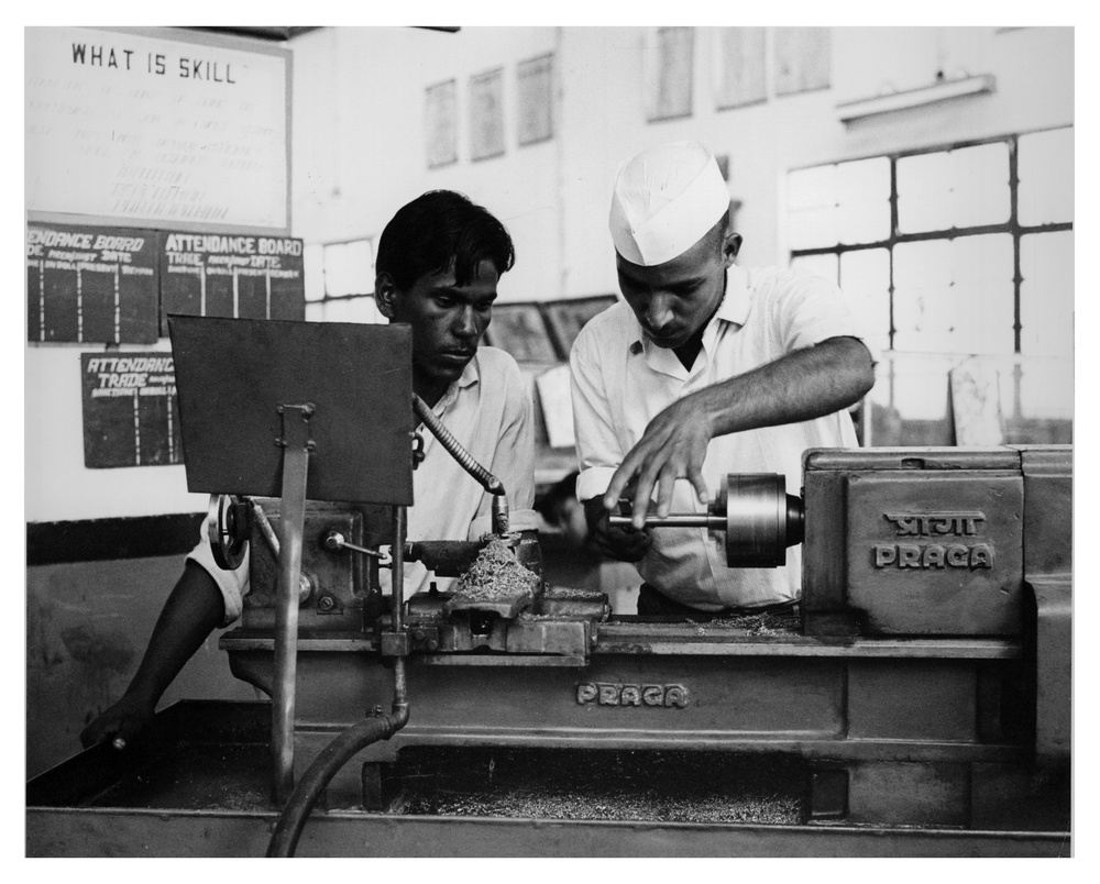 Trainees operating an engine lathe