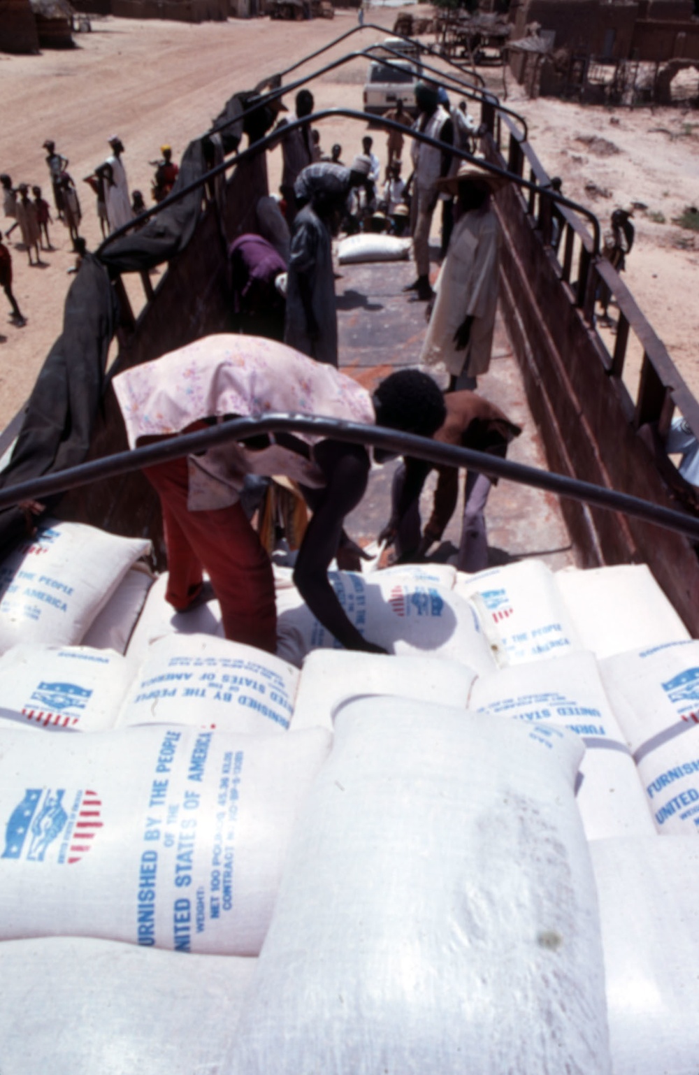 Workers unload food supplies from USAID truck