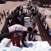 Workers unload food supplies from USAID truck