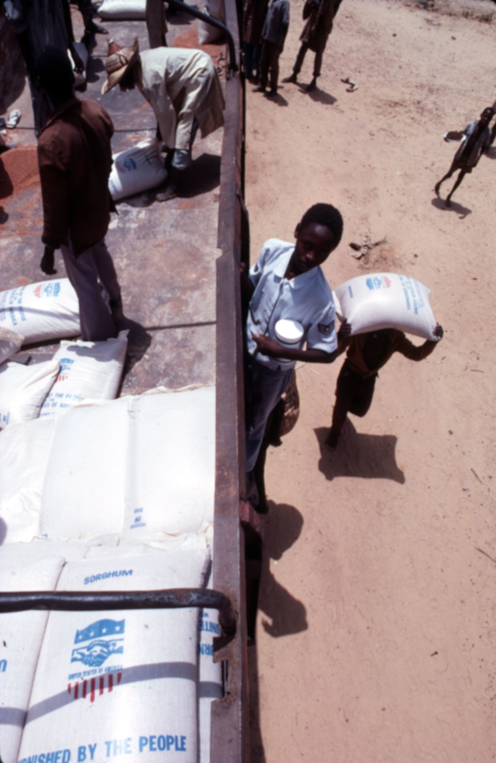 Workers unload food supplies from USAID truck