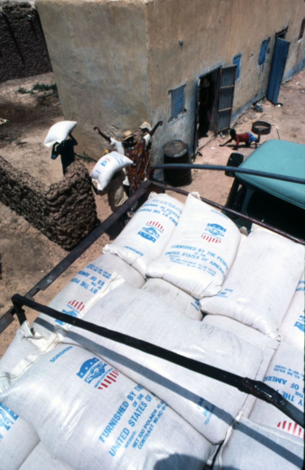 Workers unload food supplies from USAID truck