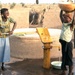 Two girls at water pump