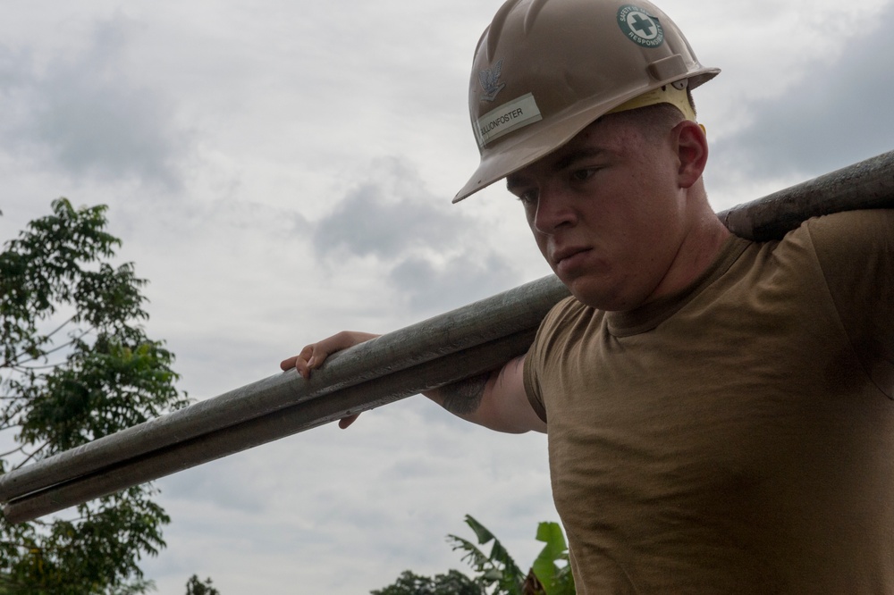 US Navy Seabees and US Air Force RED HORSE engineers build a school in Papua New Guinea during Pacific Partnership