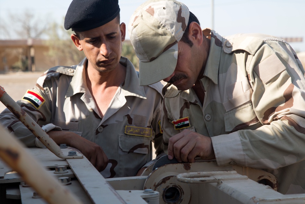 Iraqi Army Soldiers train on mine sweeping and vehicle maintenance