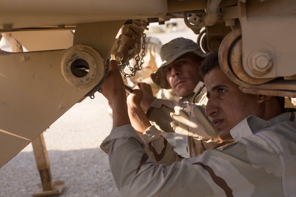 Iraqi Army Soldiers train on mine sweeping and vehicle maintenance