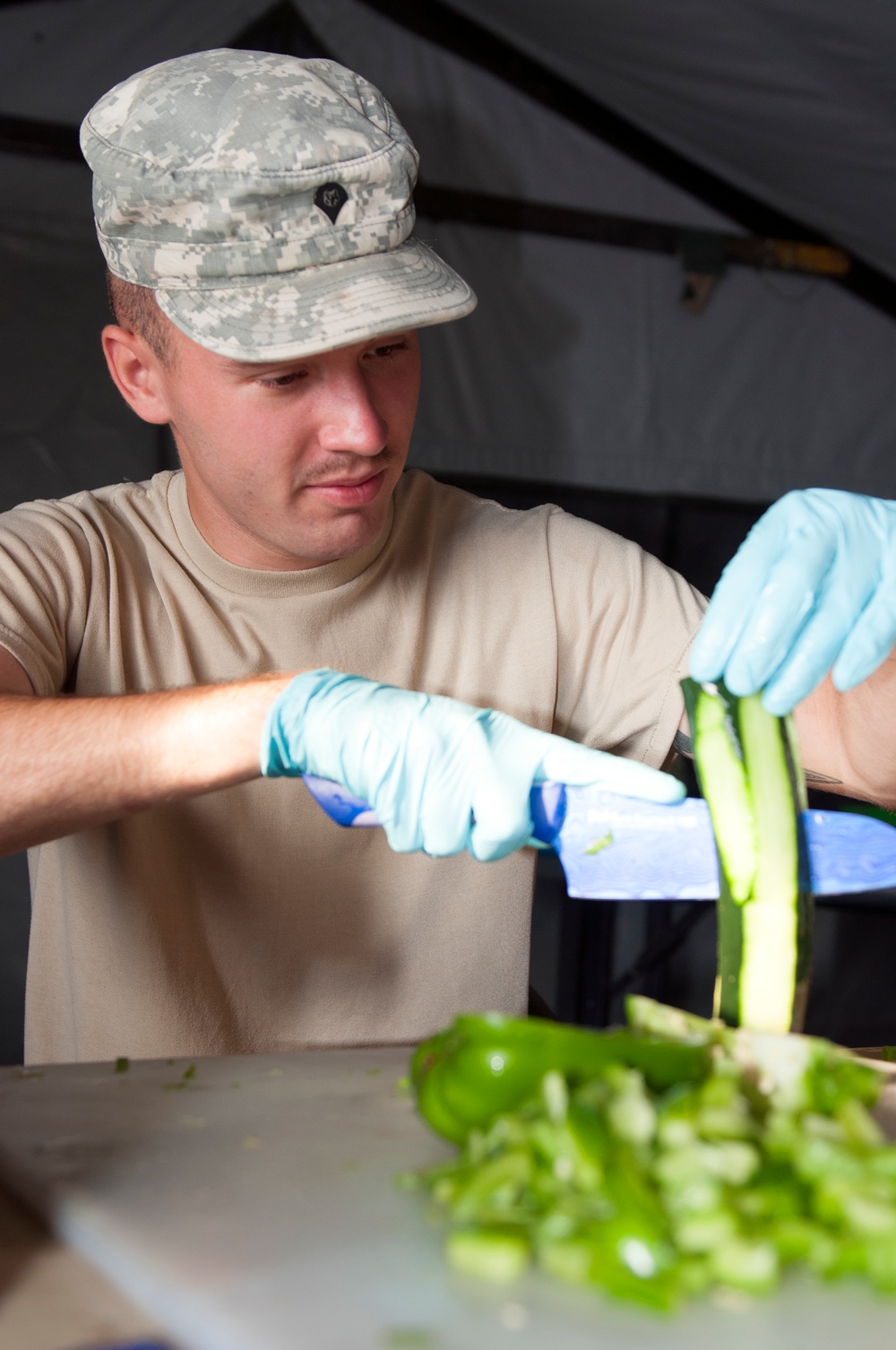 Army Reserve cook slices vegetable during competition