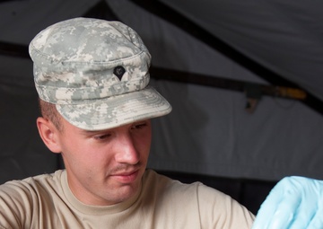Army Reserve cook slices vegetable during competition