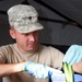 Army Reserve cook slices vegetable during competition