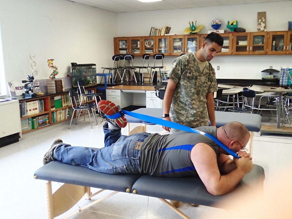 Service member provides physical therapy training to patient at IRT mission in Norwich, N.Y.