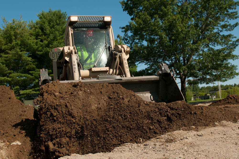 Engineer buries PVC with Skidsteer