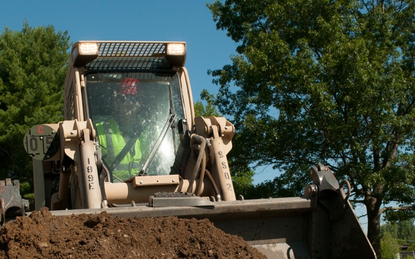 Engineer buries PVC with Skidsteer
