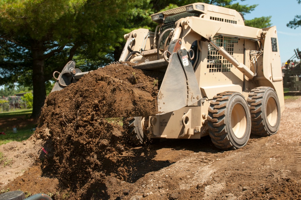 Engineer buries PVC pipe with Skidsteer