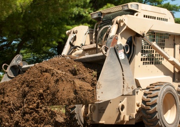 Engineer buries PVC pipe with Skidsteer