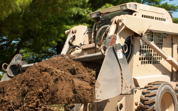Engineer buries PVC pipe with Skidsteer