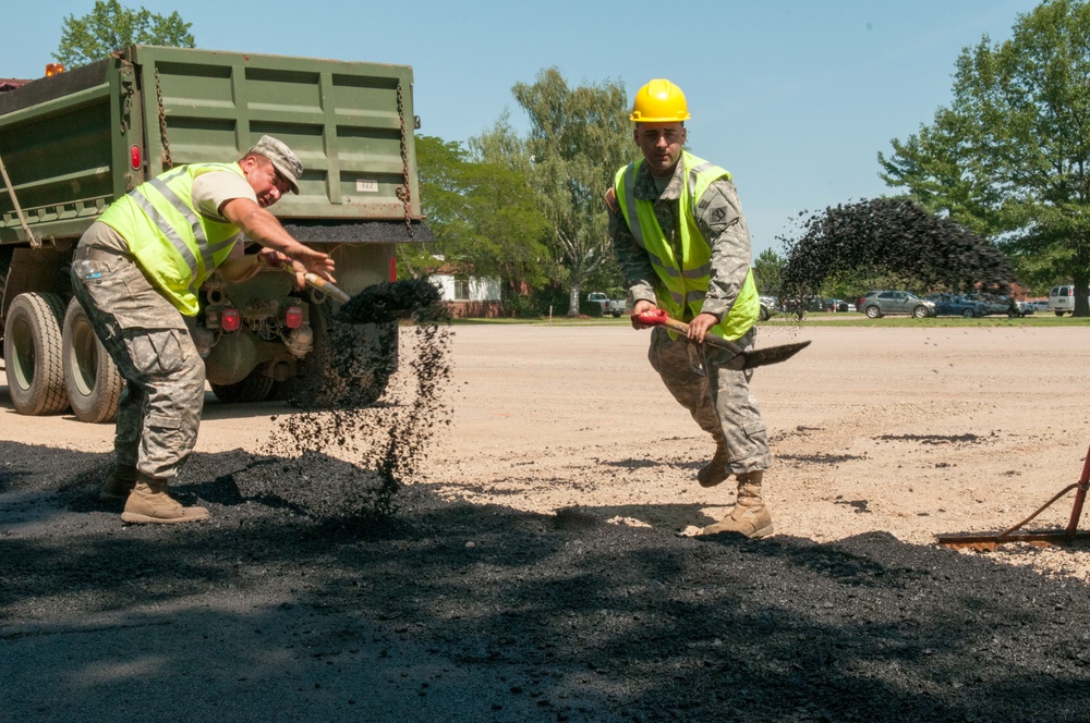 Engineers shovel asphalt