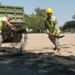 Engineers shovel asphalt