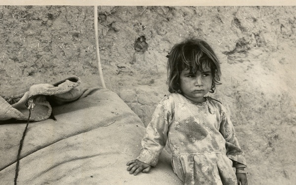 Girl sitting on a sack