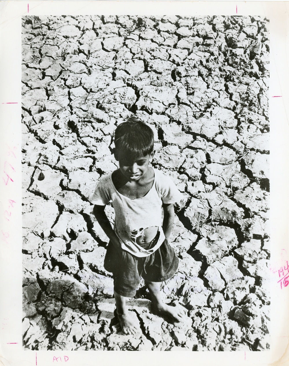 Boy standing in a dried up bed of a water tank