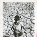 Boy standing in a dried up bed of a water tank