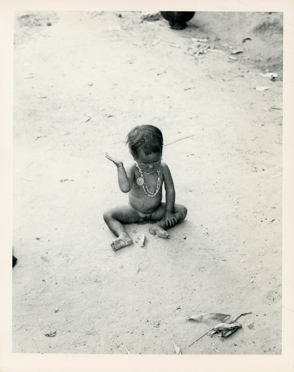 Child sitting in dirt