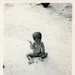 Child sitting in dirt