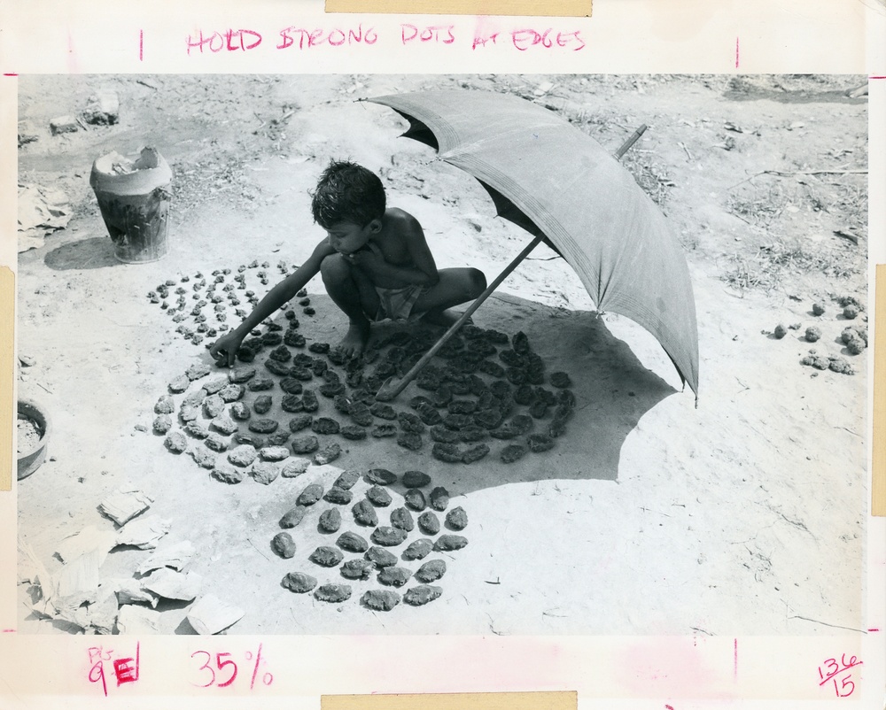 Boy under umbrella in the sun